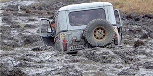 The off-road car is stuck in the ground