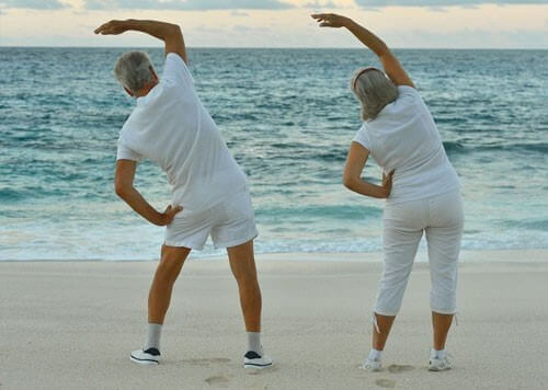 Two elderly people exercising