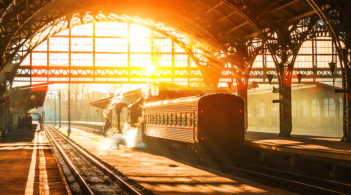 Train at the old railway station at sunset