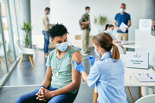 The nurse vaccinates the man